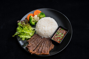 main dish food with grilled beef and rice, serve with vegetable and spicy sauce, meal meat on delicious dish for lunch, breakfast or dinner in Asian style fusion food