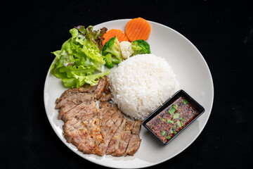 main dish food with grilled pork and rice, serve with vegetable and spicy sauce, meal meat on delicious dish for lunch, breakfast or dinner in Asian style fusion food