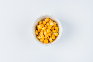 Pickled corn in a bowl. View from above. Flat lay