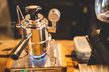 retro coffee maker tool in vintage style for using by barista, home made cafe background with old vintage machine for making a cup of hot drink with coffee or tea