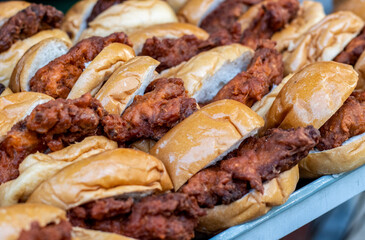 A pile of decorative delicious chicken burgers on the street market close up shot