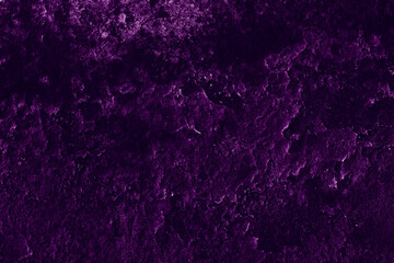 Dark purple color rugged surface of old abandoned concrete wall