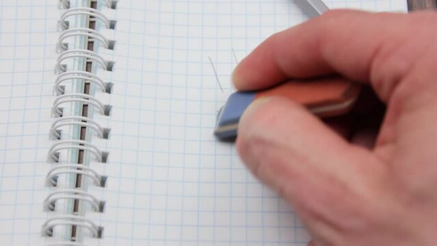 The Erase the sad emoticon with an eraser and draw a smile. Draw a smiley face with a pencil.