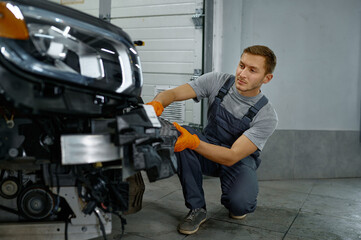 Auto mechanic worker working at car maintenance