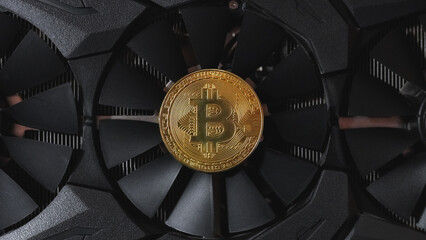 Bitcoin lies on a video card fan
