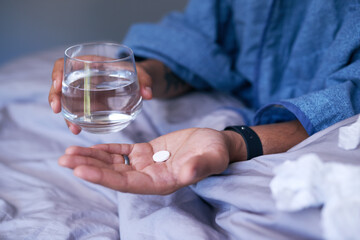 A close up of hands holding an effervescent tablet treating the flu