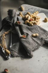 Raw peanuts cracked in the shell on the towel