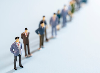 Obraz premium some miniature people lined up on a colored surface 