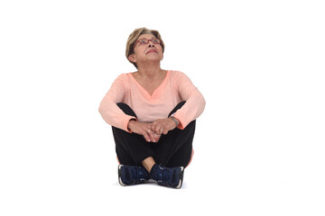 front view of senior woman sitting on the floor look up on white background