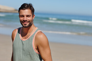 No better beach to go to. Shot of a young man enjoying a day at the beach.