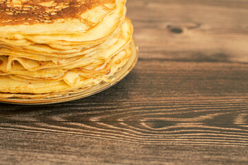 Delicious pancakes with chocolate sauce fresh blueberries on a rustic wooden table. Rustic brown table. 