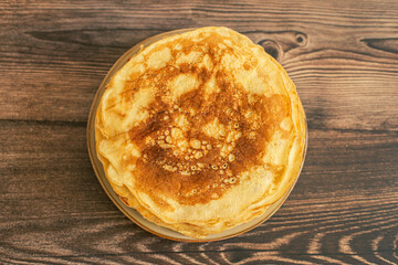 Delicious pancakes with chocolate sauce fresh blueberries on a rustic wooden table. Rustic brown table. 