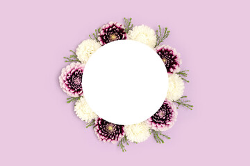 Wreath made of dahlia on a purple background. Flower frame concept with copyspace. Springtime composition.