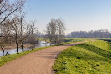 Gravel walkway along Niersdijk with green grass, The river in Germany and Holland a right tributary of the river Maas, Gennep is a municipality and a city in upper southeastern Netherlands, Nijmegen.