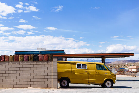 Yellow Van parked outside of gas station