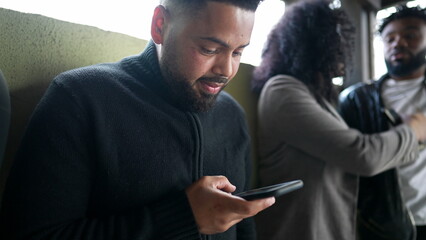 A young black black staring at phone screen