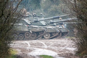 a row of parked British army FV4034 Challenger 2 main battle tank in action on a military exercise,...