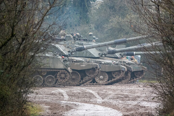 a British army Bulldog FV432 parked with a row of three FV4034 Challenger 2 main battle tanks on a...
