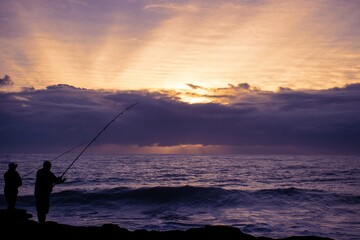 men fishing with a seascape view of the south coast of South Africa