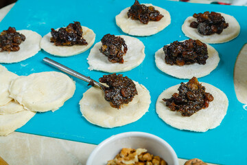 Blanks Gomentashi cookies traditional for the Jewish holiday Purim dough with stuffing on the table.