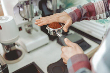 Close up of man hands holding portafilter