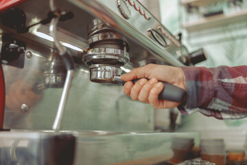 Photo of the process of installing portafilter in coffee machine