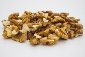 Peeled walnuts on white background