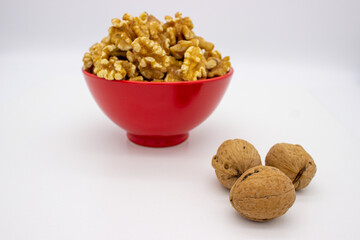 Peeled walnuts in red plate