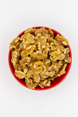 Peeled walnuts in red plate