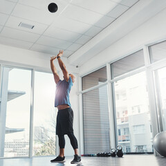 Aim high. Shot of a young man working out at the gym.