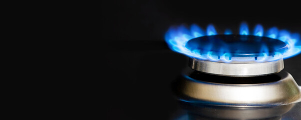 A burning gas stove. Black background. Copy space