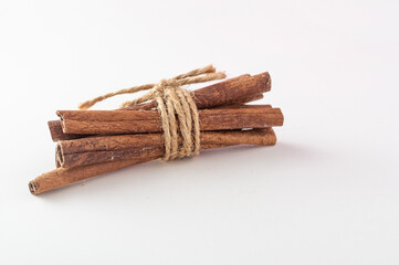 Several cinnamon sticks. Cinnamon in a pile. A bunch of cinnamon tied with a rope. Cinnamon on a...