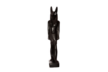 black figurine of the Egyptian god Anubis with the head of a jackal isolated on a white background