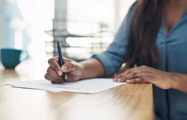 Her signature seals the deal. Closeup shot of an unrecognisable businesswoman filling in paperwork in an office.