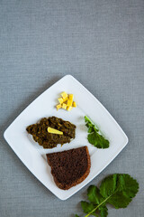 Fried turnip leaves with ginger. Vegetable greens cooking. Flat lay, top view.