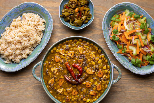 Chana Dal meal with garlic golden tarka with rice, fresh vegetable salad and spicy pickles.