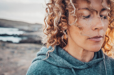 Close up portrait of woman face with closed eyes. Feeling and sensations concept. Female people in...