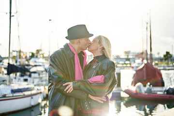 Fototapeta premium Romantic middle-aged couple kissing in the harbor