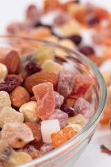 Dried fruits and nuts in a glass bowl.