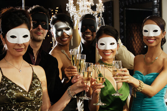 Portrait of multi-ethnic friends at masquerade party