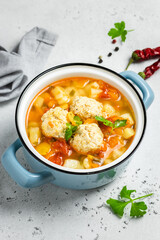 Turkey vegetable meatball soup in pot. Copy space.