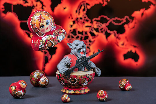 Armed monster with an evil grin jumps out of a matryoshka doll. Сoncept of military aggression.