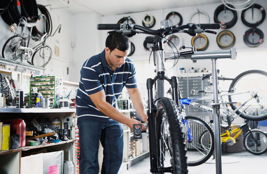 Man repairing bike in bike shop