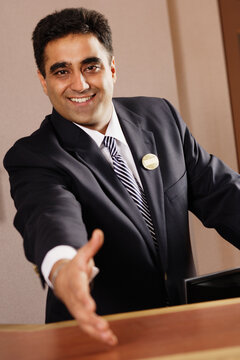 Businessman Reaching Out To Shake The Camera's Hand