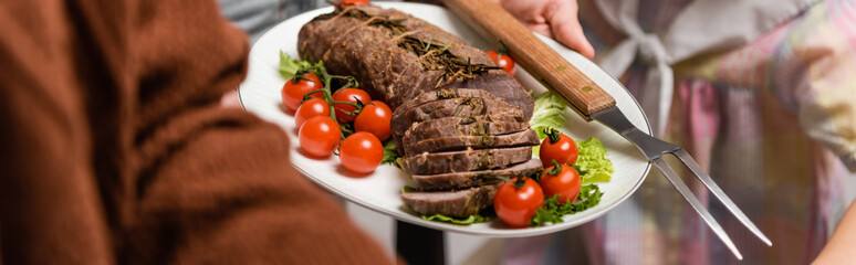 selective focus of fried meat with fresh vegetables near cropped family, banner.