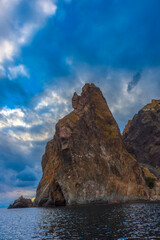 rocks of Cape Fiolent against the background of the evening sky with clouds