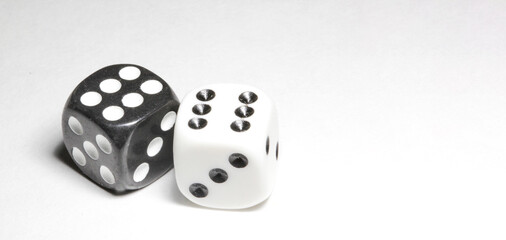 two white and black dices on a white background Win or lose Catch your luck Gambling equipment - obrazy, fototapety, plakaty