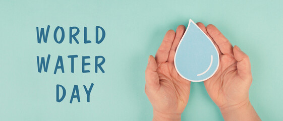 World water day, Hands holding a drop of water, paper cut out, environmental issue

