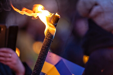 Ukrainian flags, candles and torches in the hands of protesters at the rally 