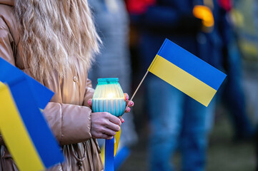 Ukrainian flags, candles and torches in the hands of protesters at the rally 